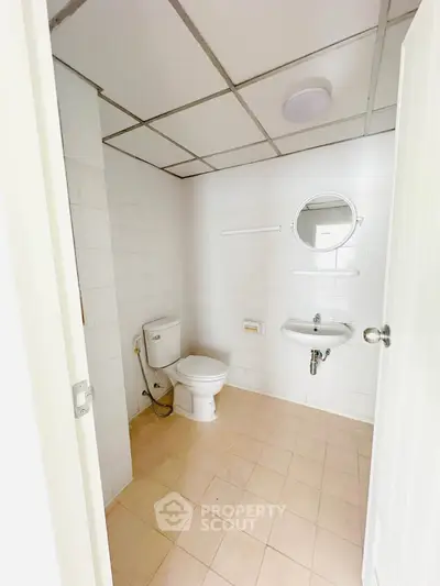 Spacious bathroom with modern fixtures and tiled flooring