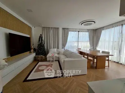 Luxurious living room with elegant decor and large windows offering abundant natural light.