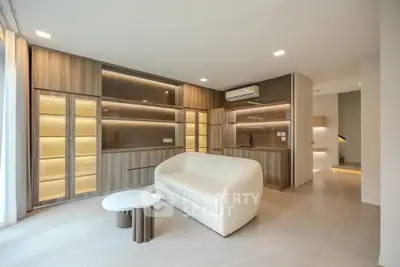 Modern living room with sleek design and integrated kitchen area