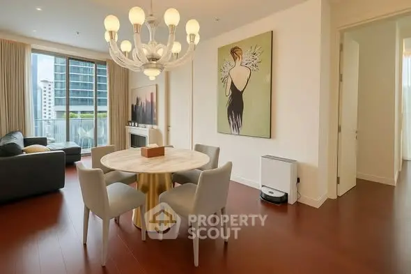 Elegant living room with modern chandelier and stylish decor in a high-rise apartment.