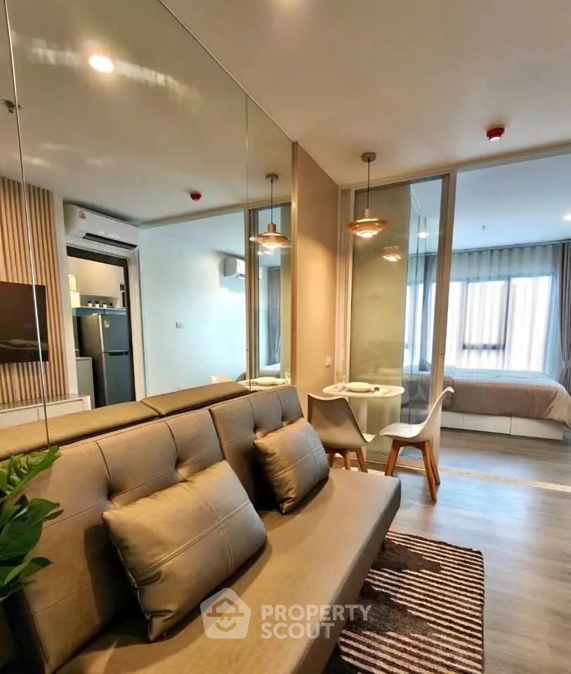 Modern apartment interior with cozy living room and stylish bedroom, featuring sleek furniture and ambient lighting.