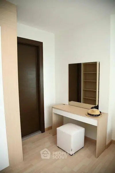 Modern bedroom corner with stylish vanity and mirror, perfect for personal grooming and storage.