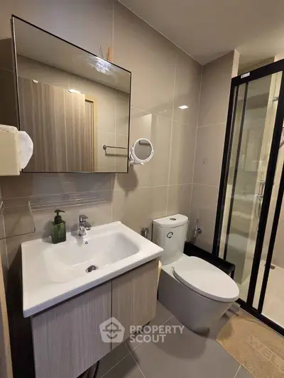 Modern bathroom with sleek fixtures and glass shower enclosure