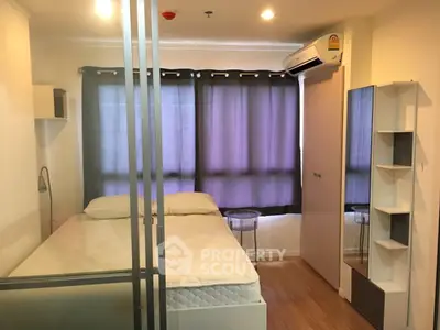 Cozy bedroom with modern furnishings and ample natural light, featuring a comfortable bed and stylish decor.