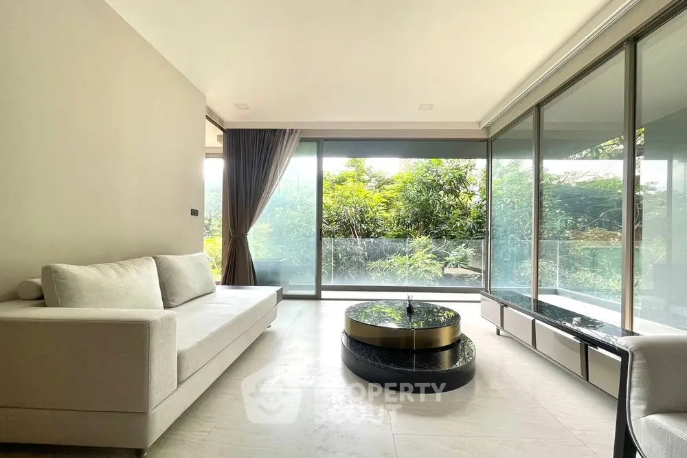 Luxurious modern living room with floor-to-ceiling windows and garden view