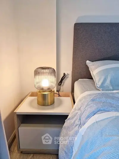 Cozy bedroom with stylish bedside lamp and modern decor