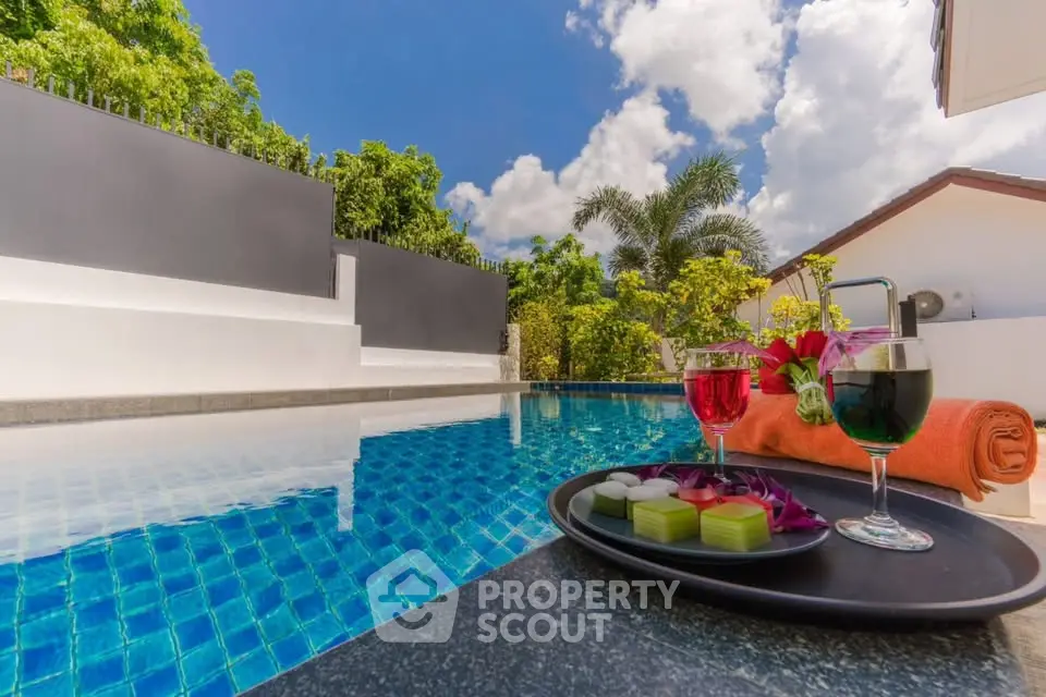 Luxurious poolside retreat with tropical drinks and lush greenery, perfect for relaxation and leisure.