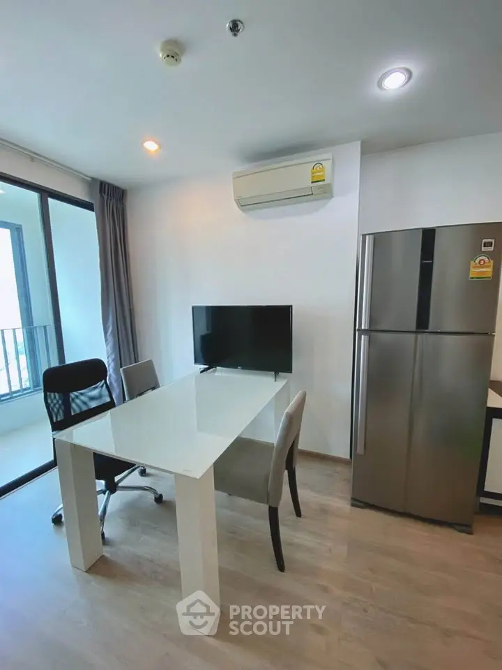 Modern apartment interior with sleek dining area and balcony view