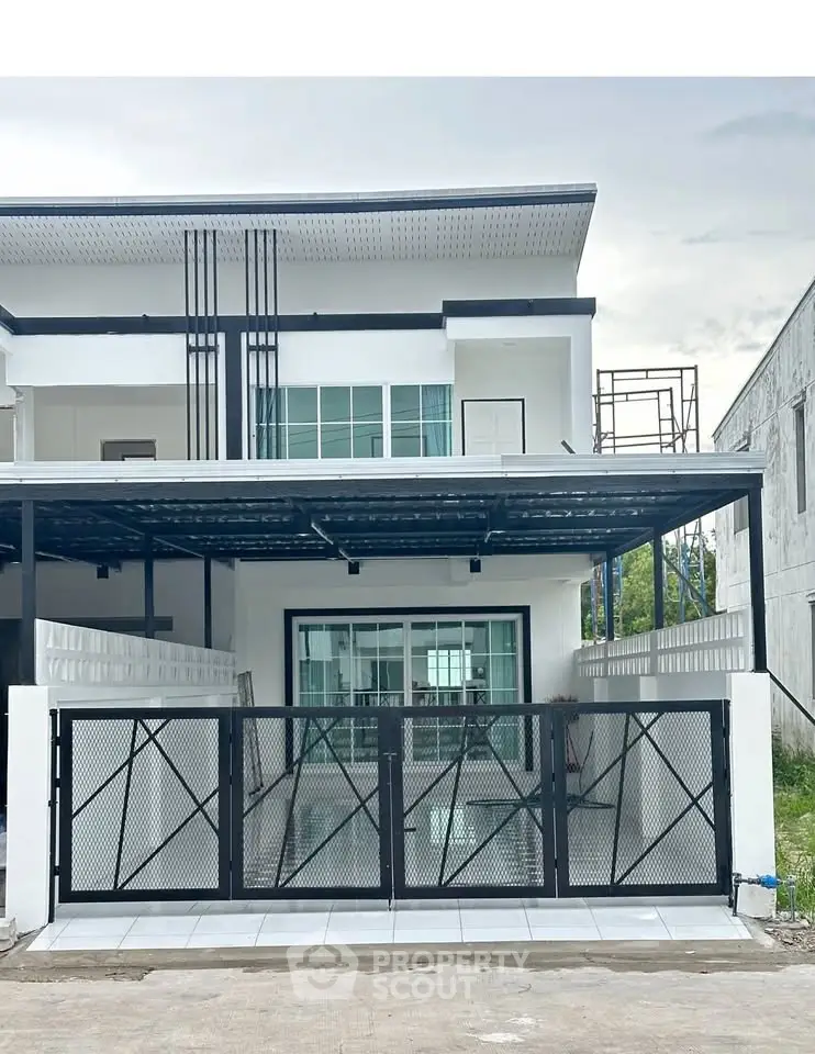 Modern two-story house with sleek design and spacious driveway