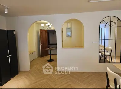 Stylish interior with arched doorway and modern decor in a spacious living area.