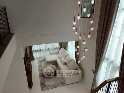 Elegant living room with high ceiling and modern chandelier