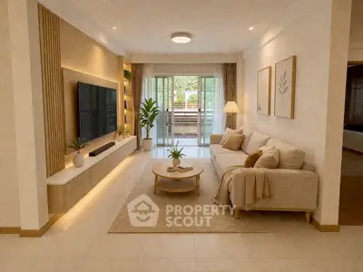 Spacious modern living room with elegant decor and large TV, opening to a balcony with greenery view.