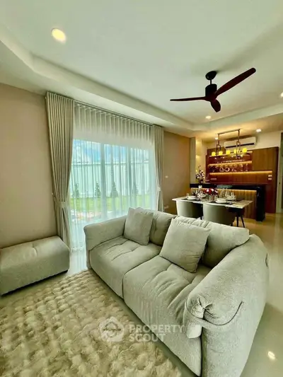 Luxurious living room with plush sofa and elegant dining area, perfect for modern living.