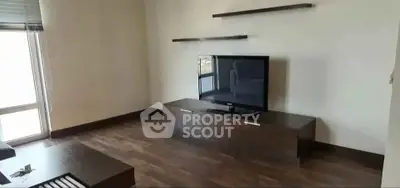 Modern living room with sleek TV stand and minimalist shelves