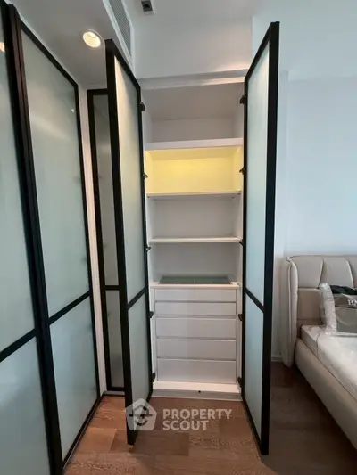 Modern bedroom with sleek built-in storage and frosted glass doors