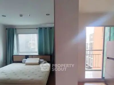 Spacious bedroom with large window and balcony access in modern apartment