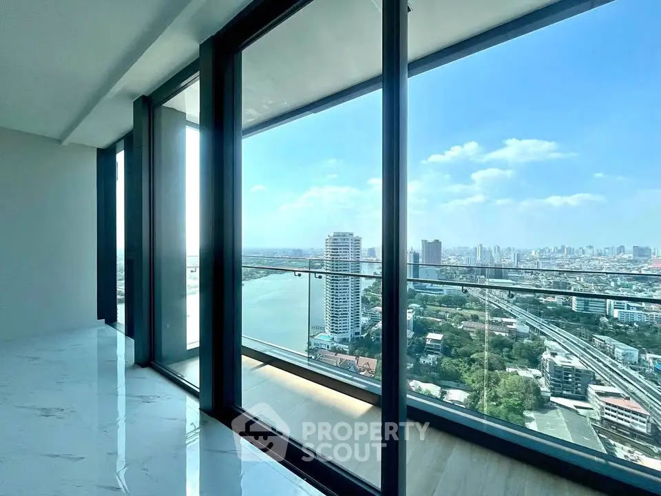 Stunning high-rise apartment with panoramic city and river views from floor-to-ceiling windows.