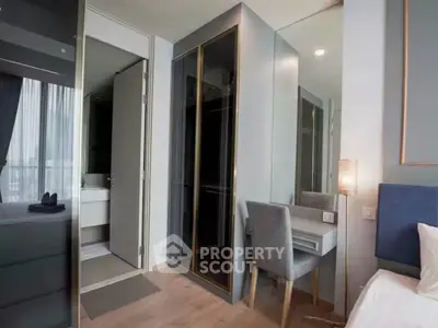 Modern bedroom with stylish furniture and ensuite bathroom in luxury apartment.