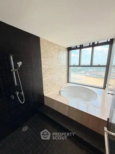 Luxurious bathroom with a round bathtub and city view, featuring modern black tile design.
