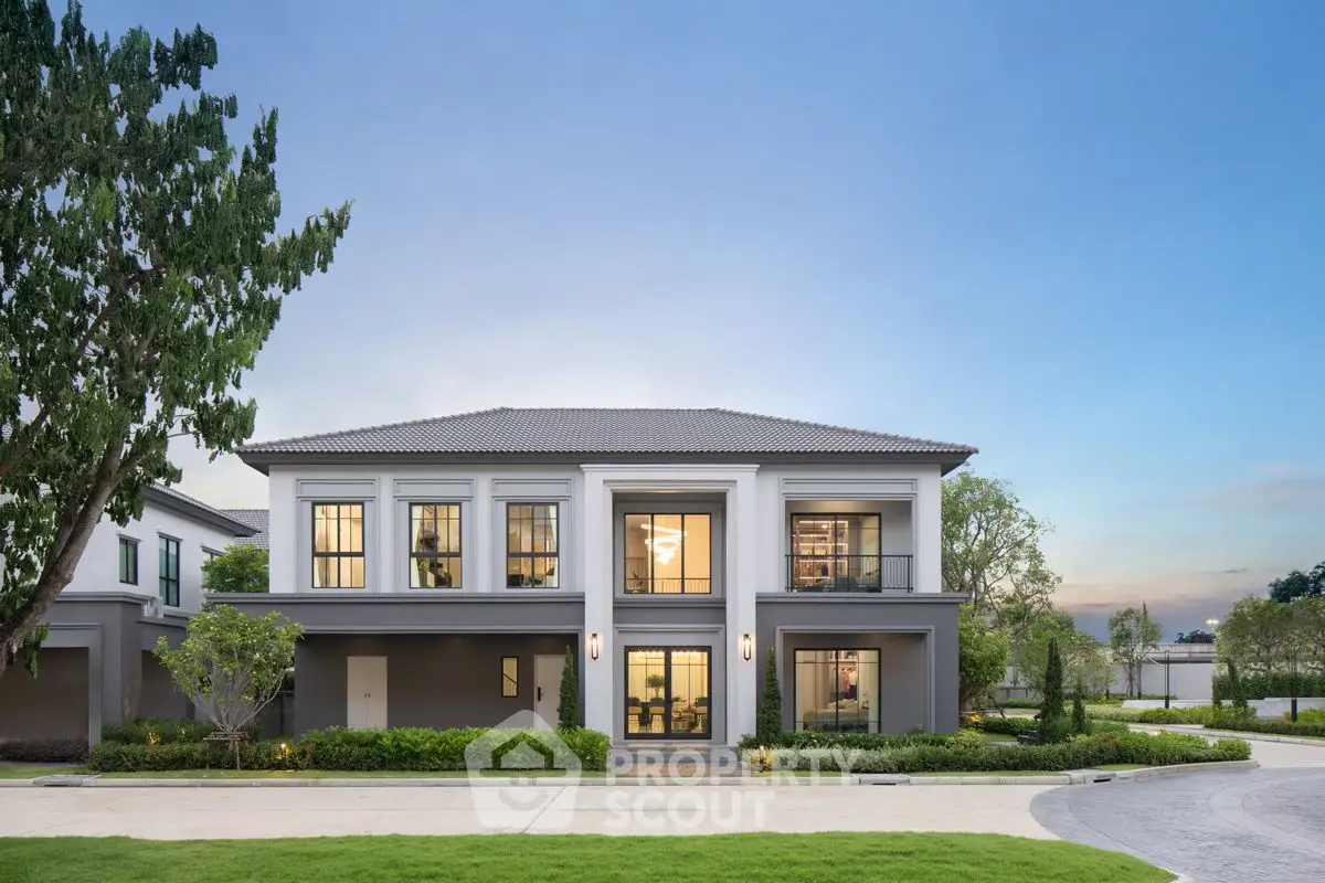 Stunning modern two-story house with lush landscaping and elegant facade.