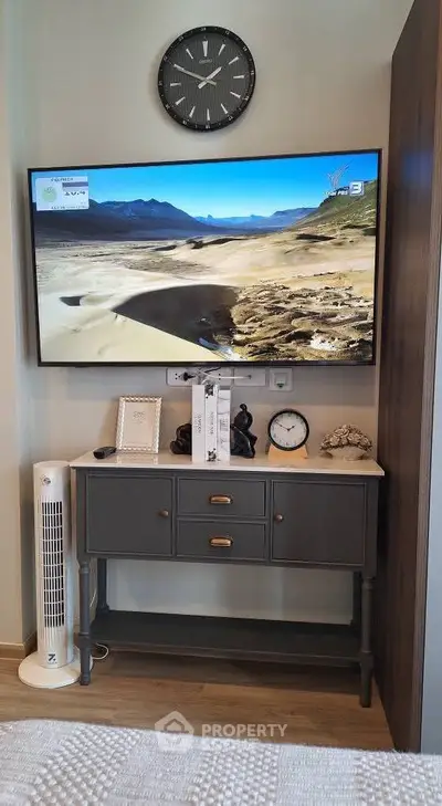Stylish living room corner with wall-mounted TV and elegant console table.