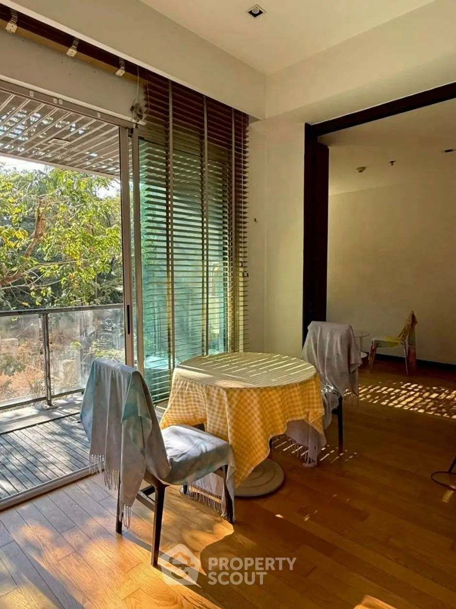 Charming dining area with natural light and balcony access in modern apartment.