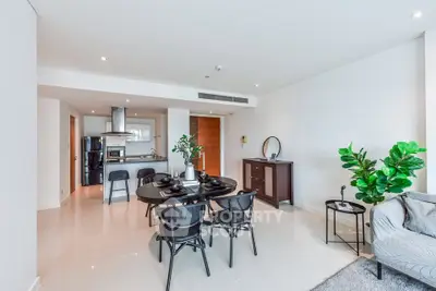 Modern open-plan living and dining area with sleek kitchen and stylish decor.