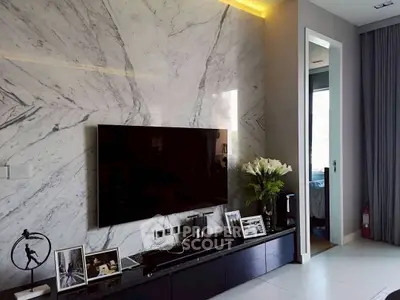 Luxurious living room with marble accent wall and modern entertainment setup