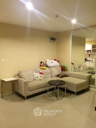 Modern living room with cozy beige sofa and stylish decor in a contemporary apartment.