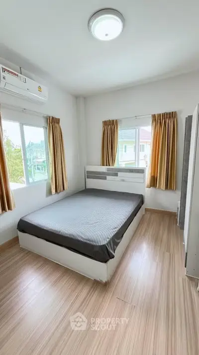 Bright and airy bedroom with large windows and modern furnishings