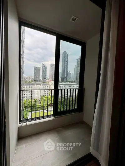 Modern apartment balcony with stunning city view and large windows