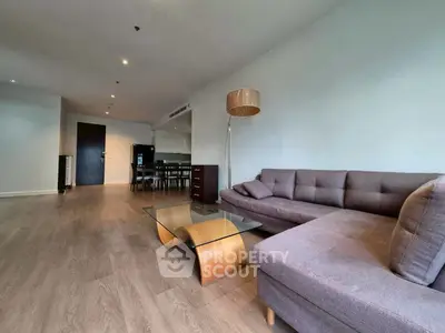 Spacious modern living room with stylish furniture and wooden flooring