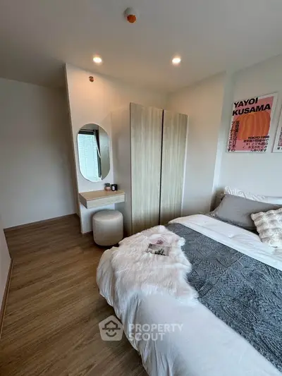 Cozy bedroom with modern decor and stylish furniture, featuring a plush bed and elegant wardrobe.