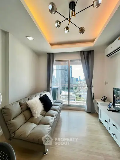 Modern living room with stylish lighting and city view from balcony.