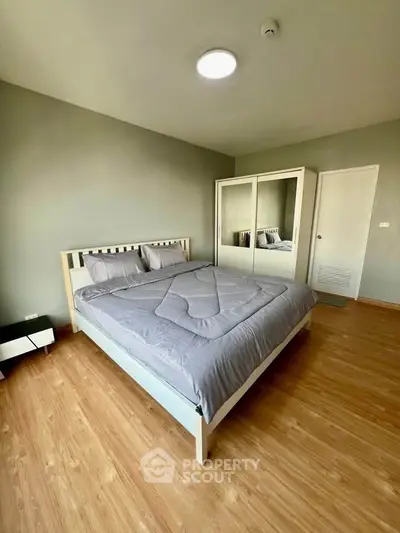 Spacious bedroom with modern decor and ample natural light
