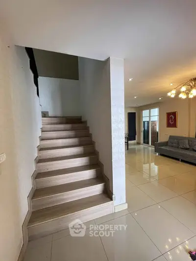 Modern interior with wooden staircase and spacious living area