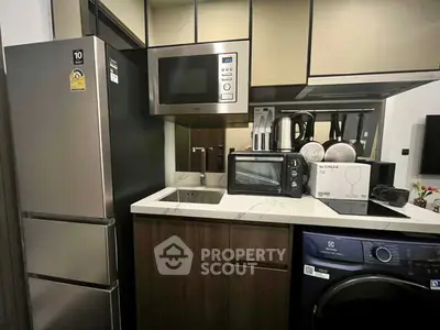 Modern kitchen with stainless steel appliances and compact design