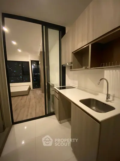 Modern kitchen with sleek cabinetry and city view