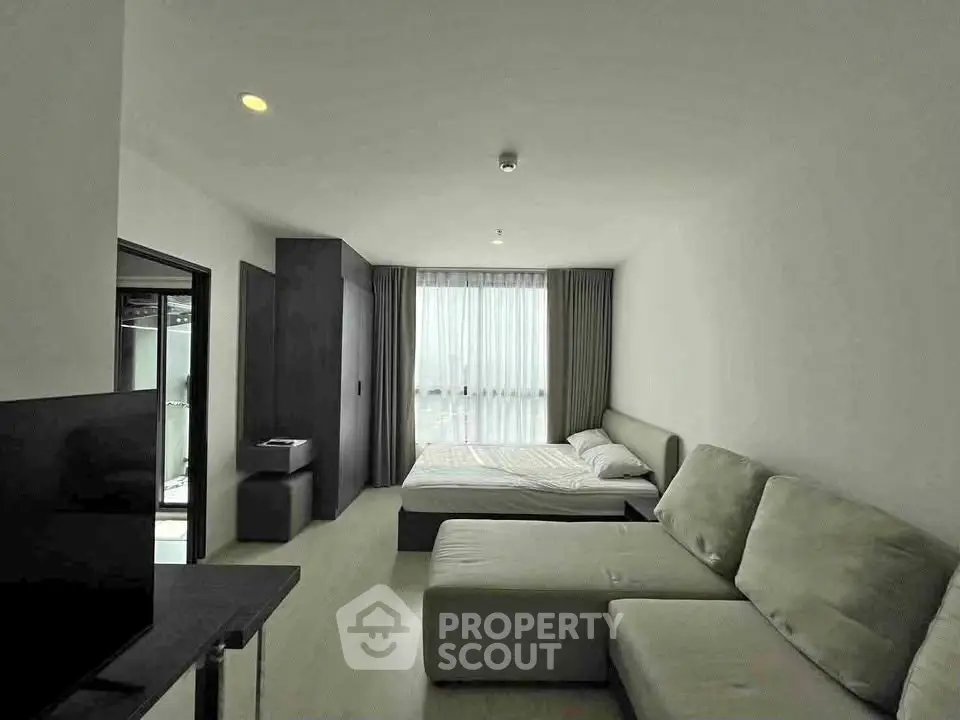Modern studio apartment with cozy living area and natural light