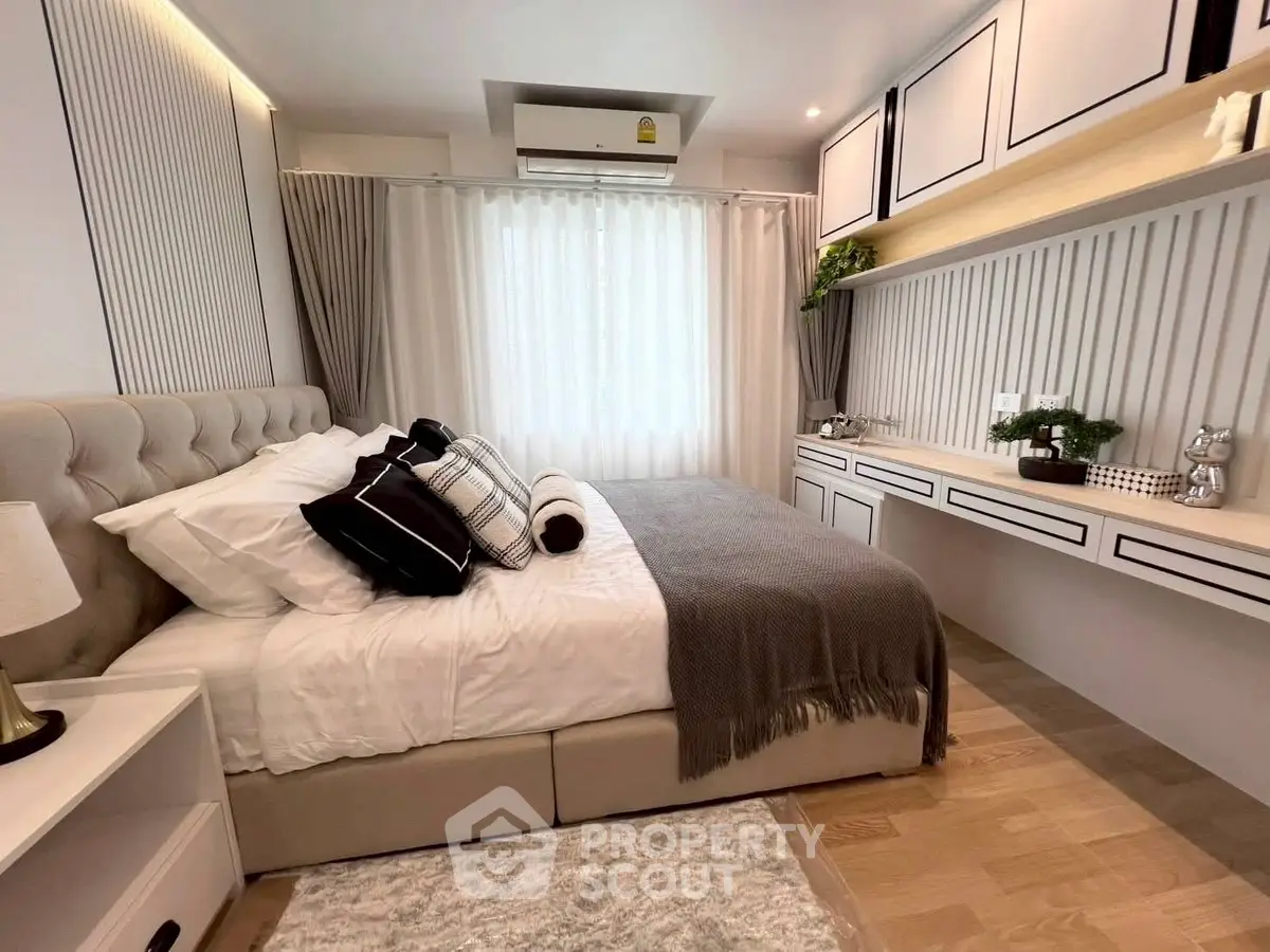Modern bedroom with elegant decor and ample natural light