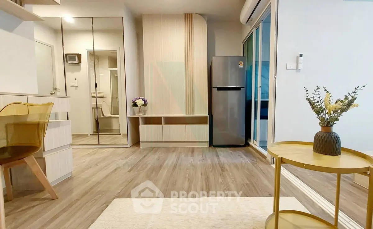 Modern living room with stylish decor and sleek appliances in a cozy apartment setting.