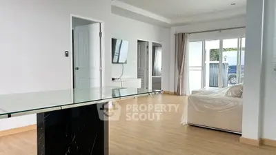 Spacious modern living room with sleek design and large windows for natural light.