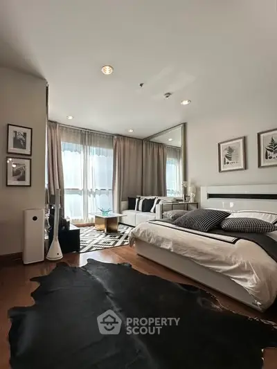 Modern bedroom with stylish decor and natural light