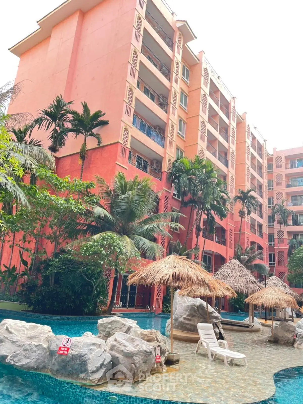 Luxurious tropical resort with poolside cabanas and lush greenery