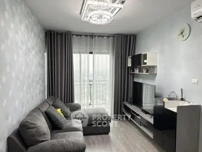 Modern living room with stylish decor and city view from balcony.