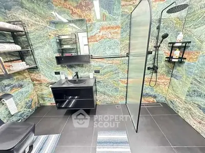 Luxurious modern bathroom with vibrant stone walls and sleek black fixtures.