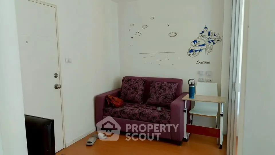 Cozy living room with purple sofa and wall art in modern apartment