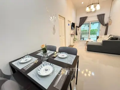 Modern living room with dining area, stylish decor, and cozy seating.