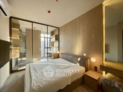 Modern bedroom with large windows and stylish wooden accents, featuring a cozy bed and ample natural light.
