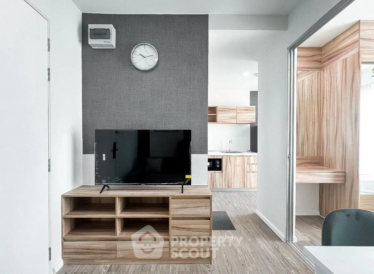 Modern living room with sleek TV stand and open kitchen layout